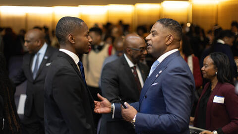 Student networking and shaking hands at a professional event